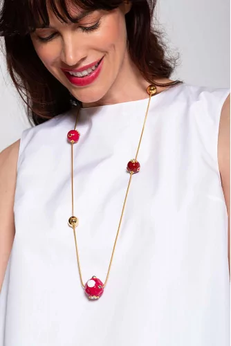 Long gold plated necklace with resin red balls